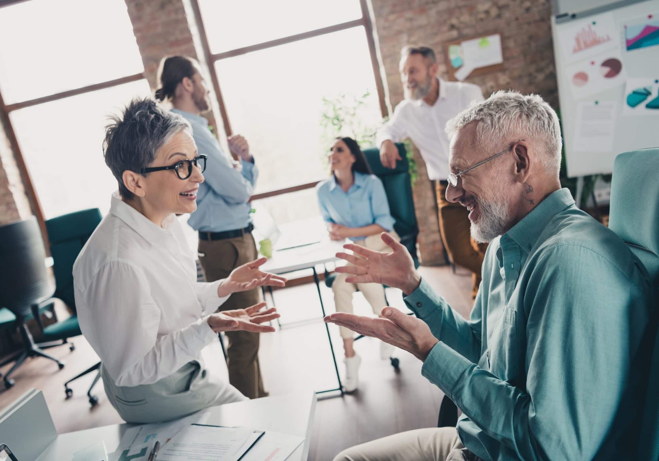 Professionals talking and sharing ideas during a team meeting in an office