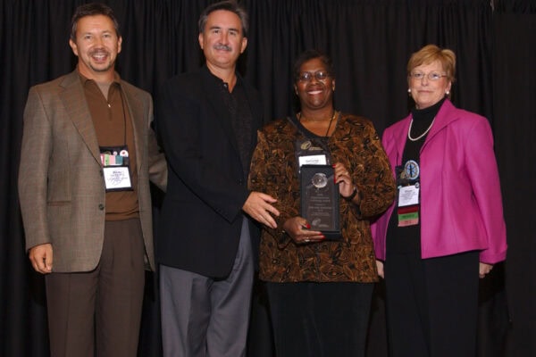 Group photo of the 2005 ICF Prism Award winners, celebrating the inaugural year of the award for organizations with strong coaching cultures.