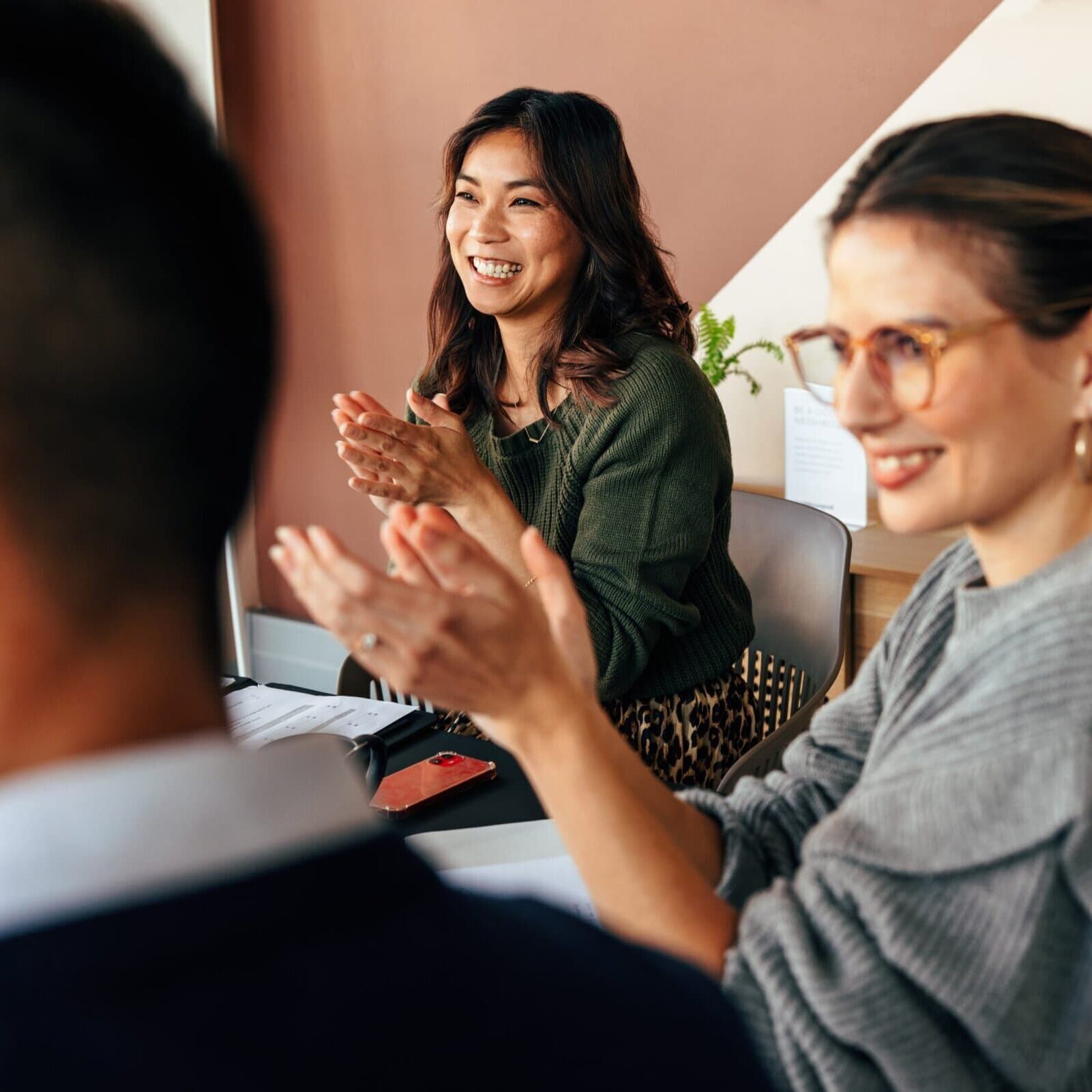Cheerful,Businesspeople,Applauding,During,An,Office,Meeting.,Group,Of,Multicultural