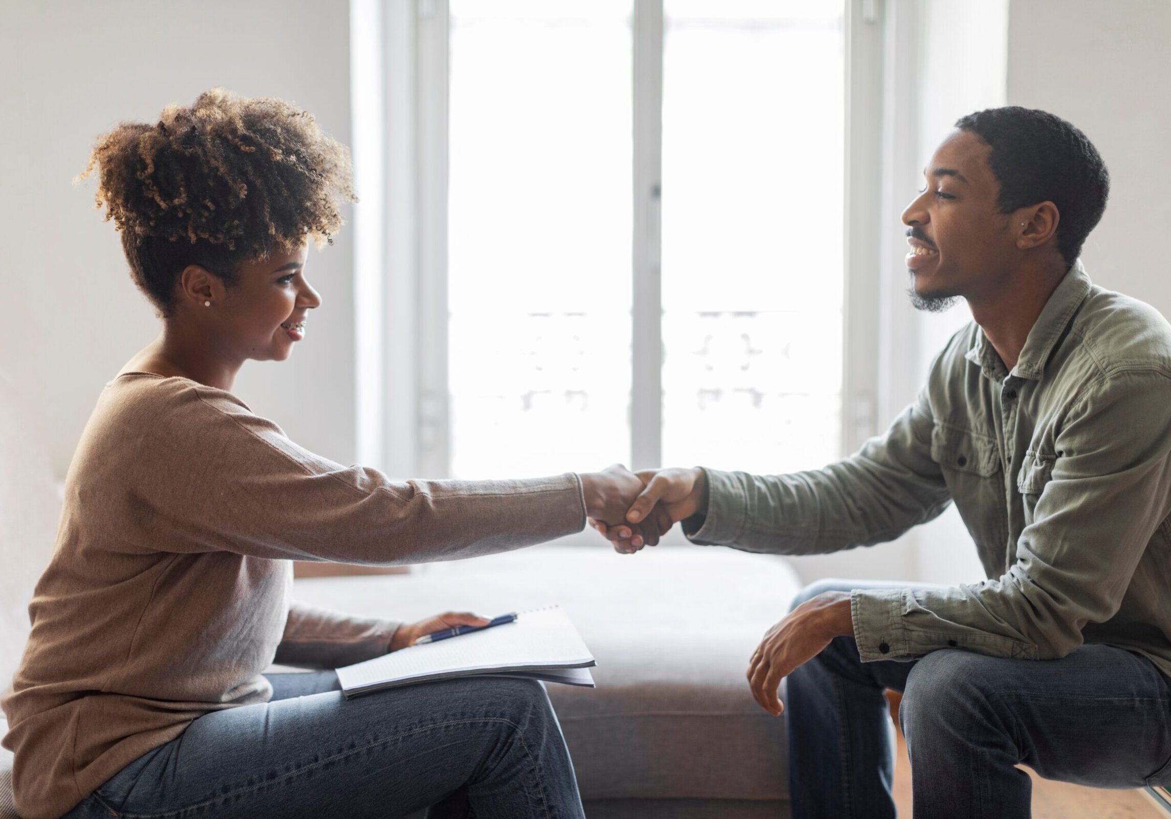 Coach and client shaking hands during a professional coaching session