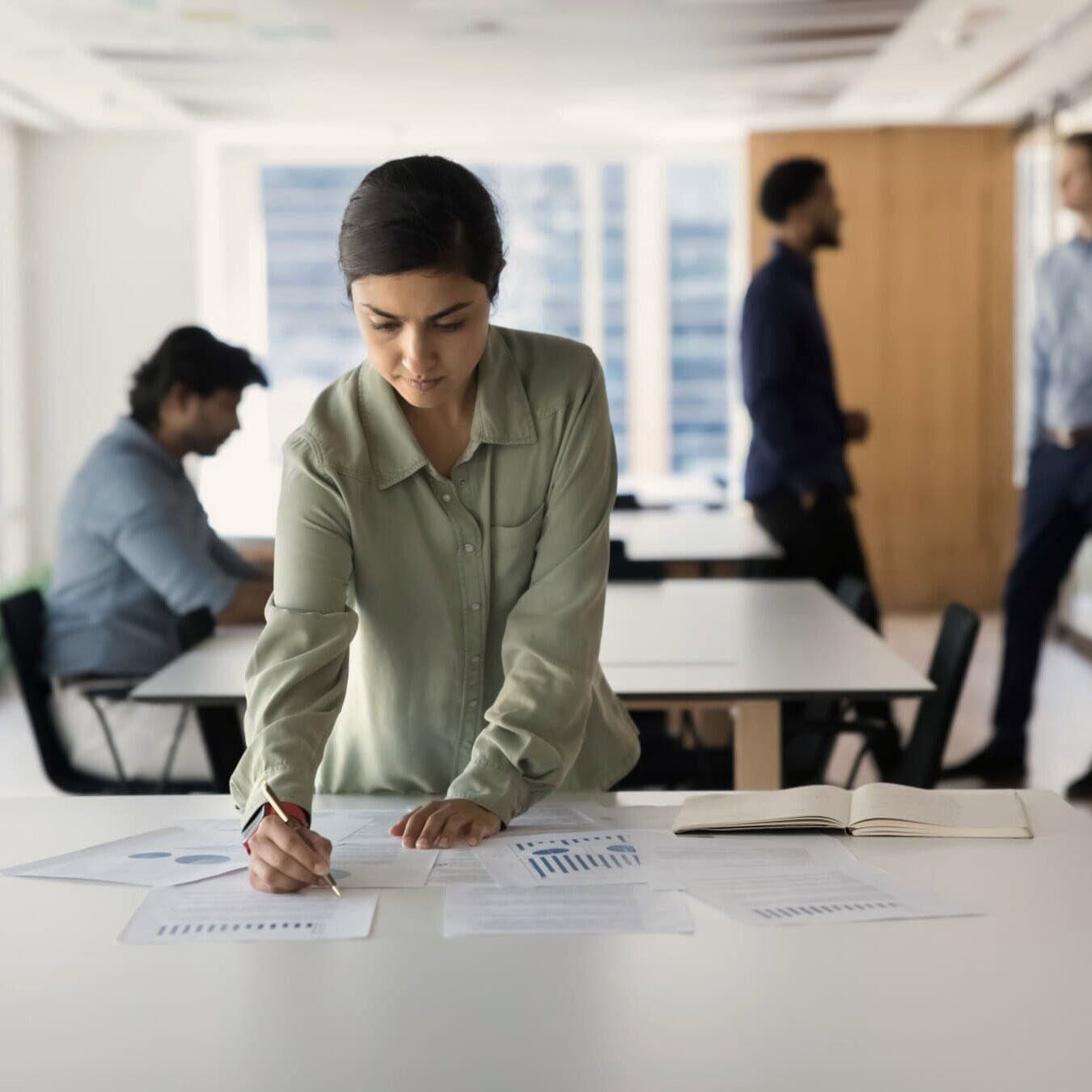 A woman is looking through the ethical resources in an office.
