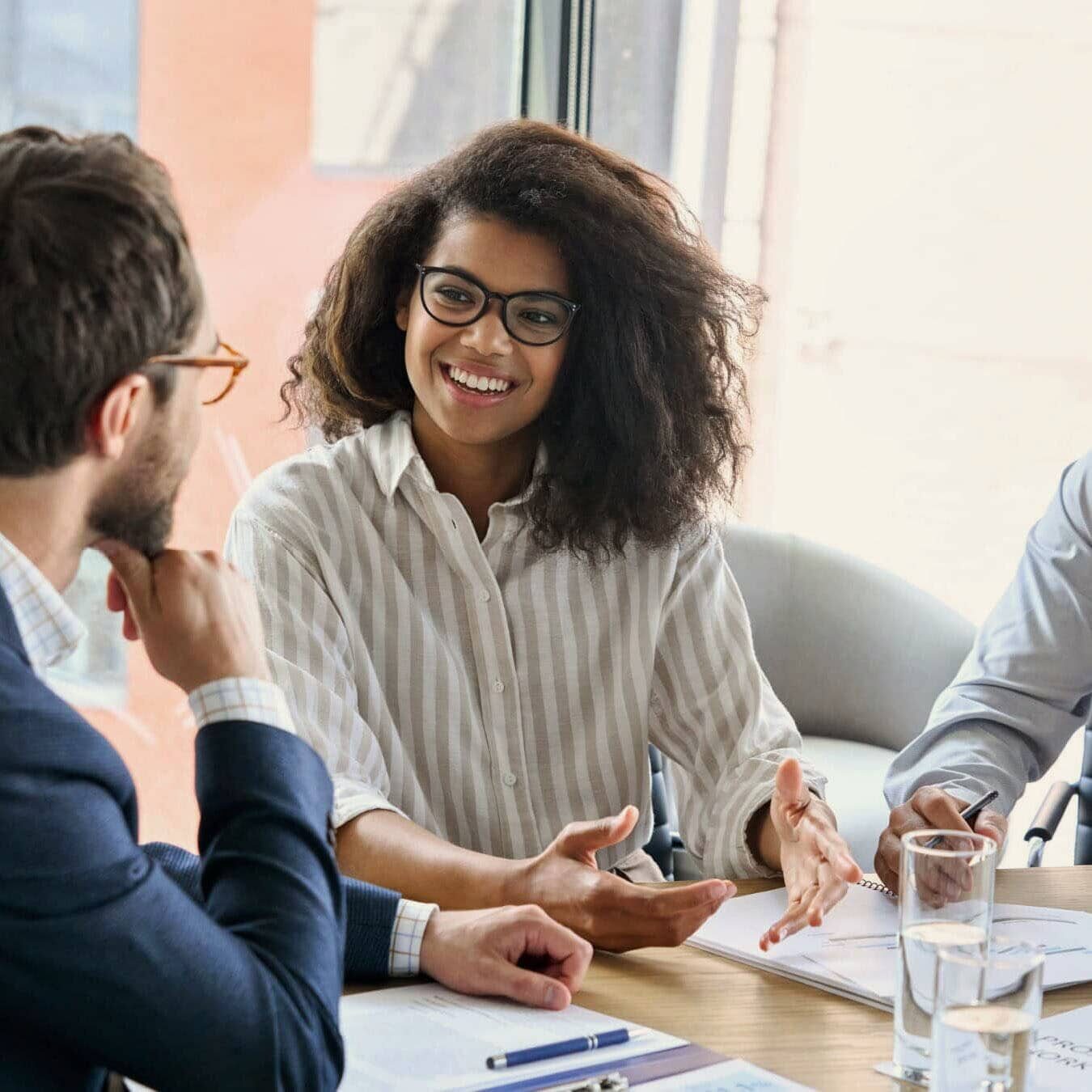 A group of professional coaches work together in an office to determine next steps