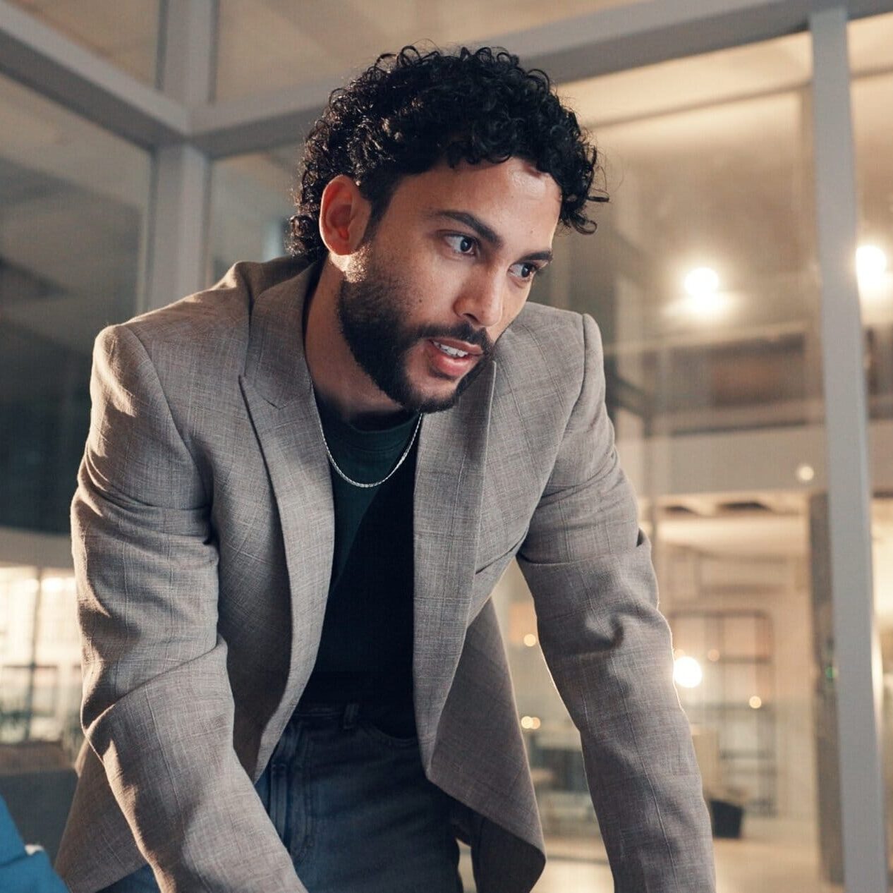 Two business professionals in an office reviewing information together on a desktop computer