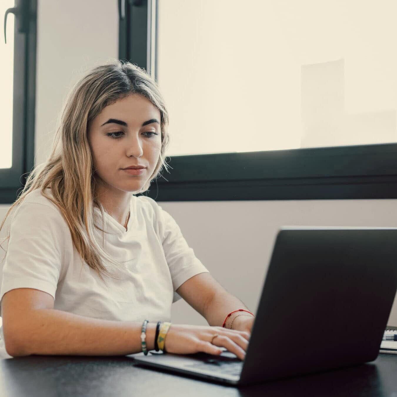 Woman takes her ICF Credential exam remotely.