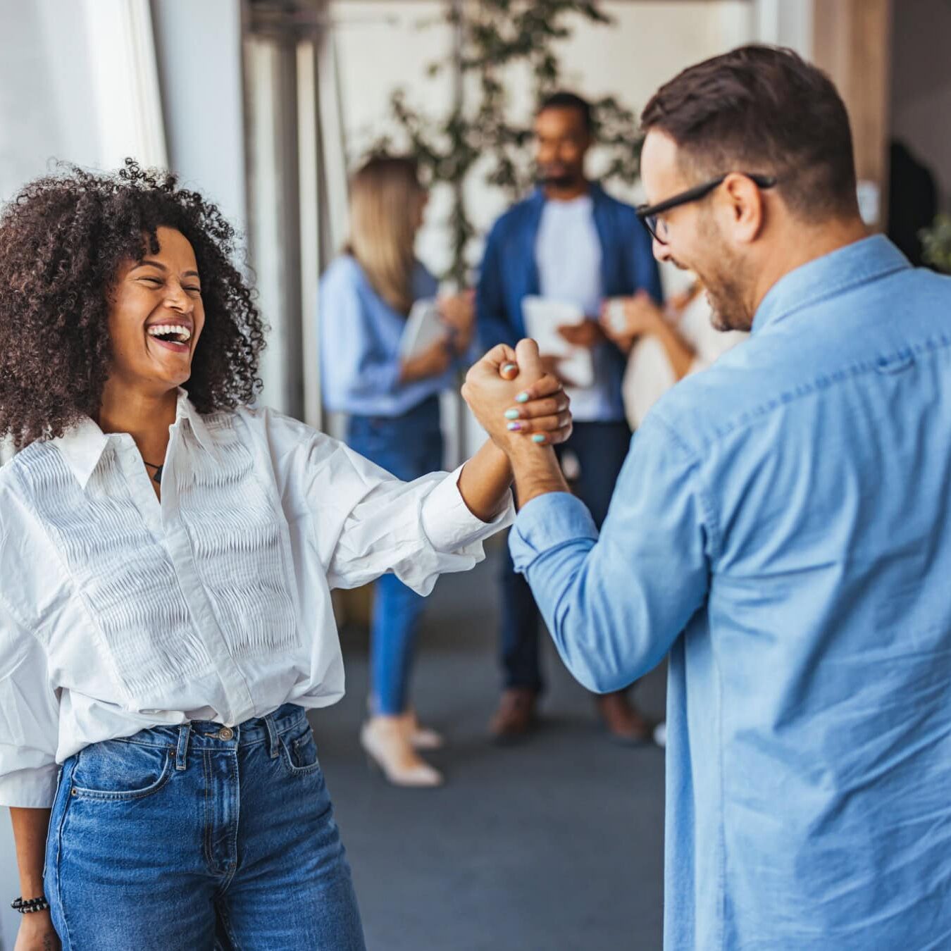 A man and a woman shake hands celebrating all of the Credentialing Resources.