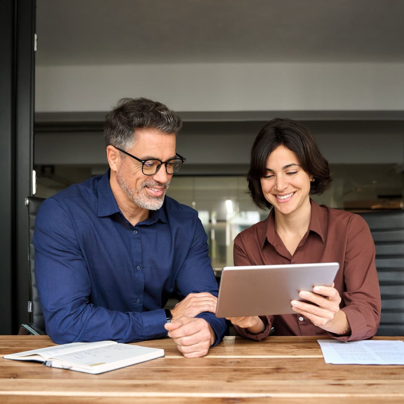 Two people look at a tablet to view the ICF Featured events