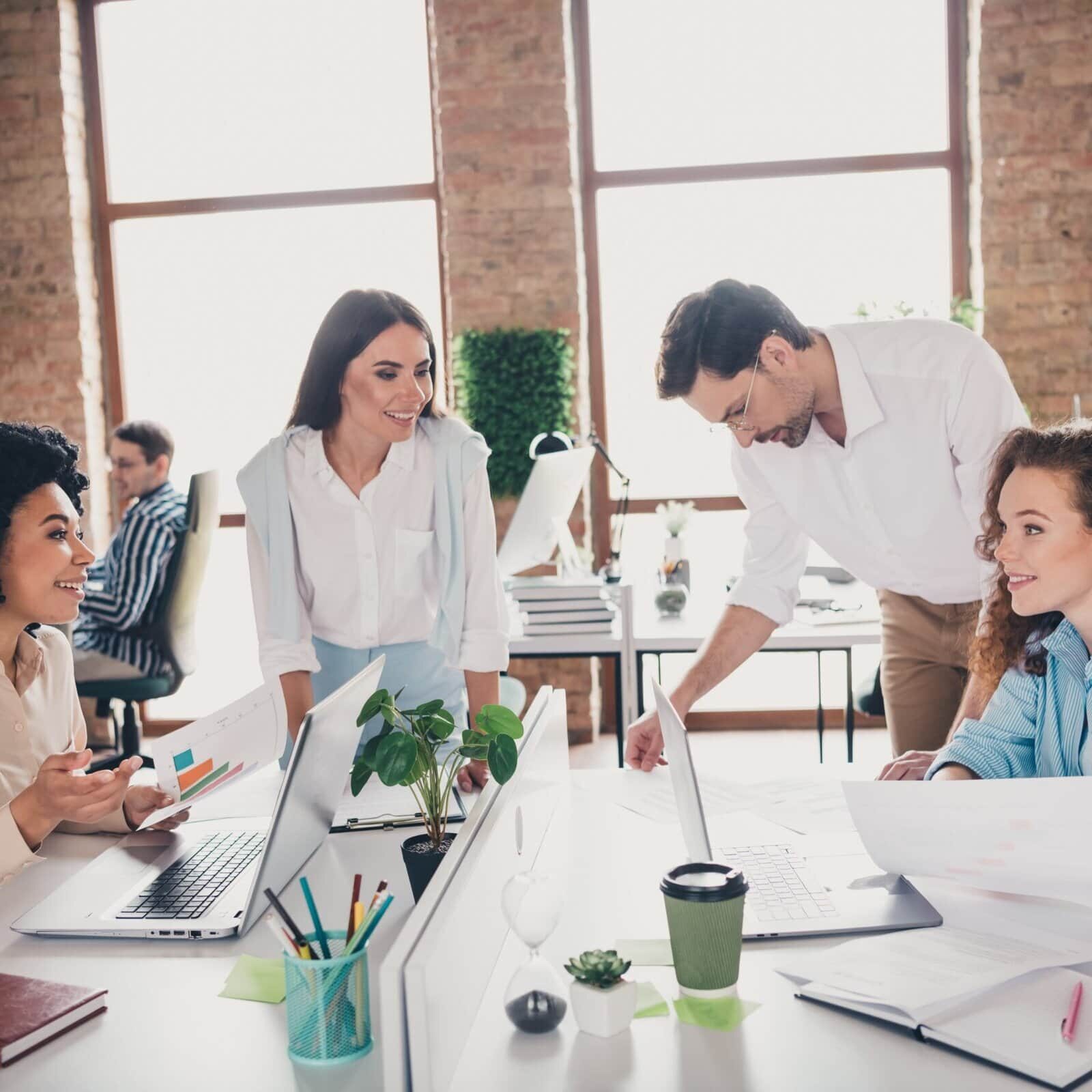 Team of professionals collaborating around a workspace table in a modern office