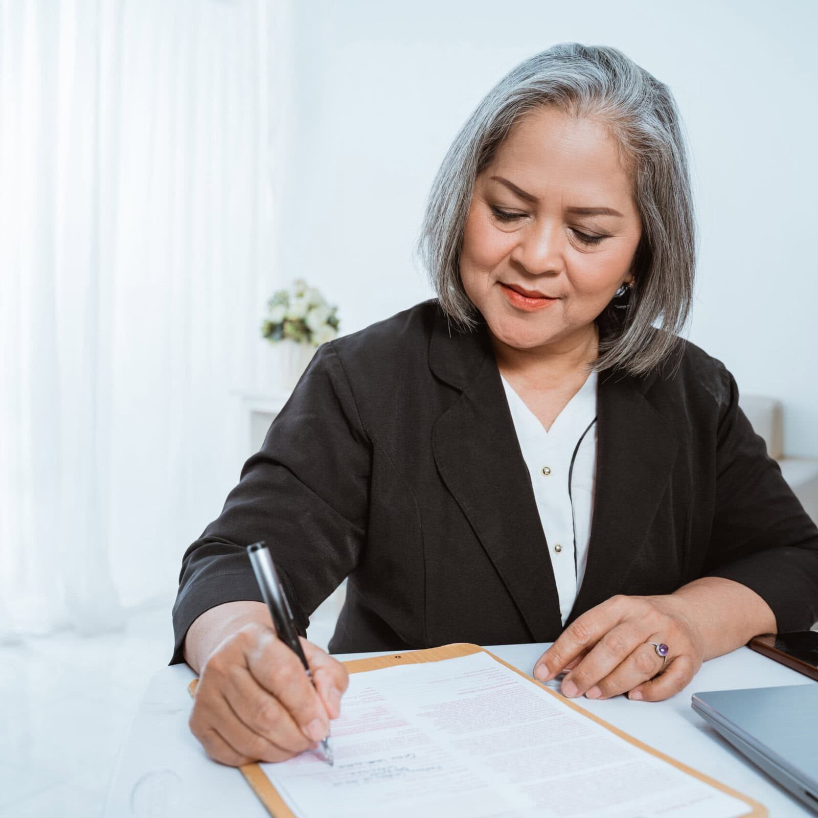 A woman is documenting her mentor coaching experience for her credential application