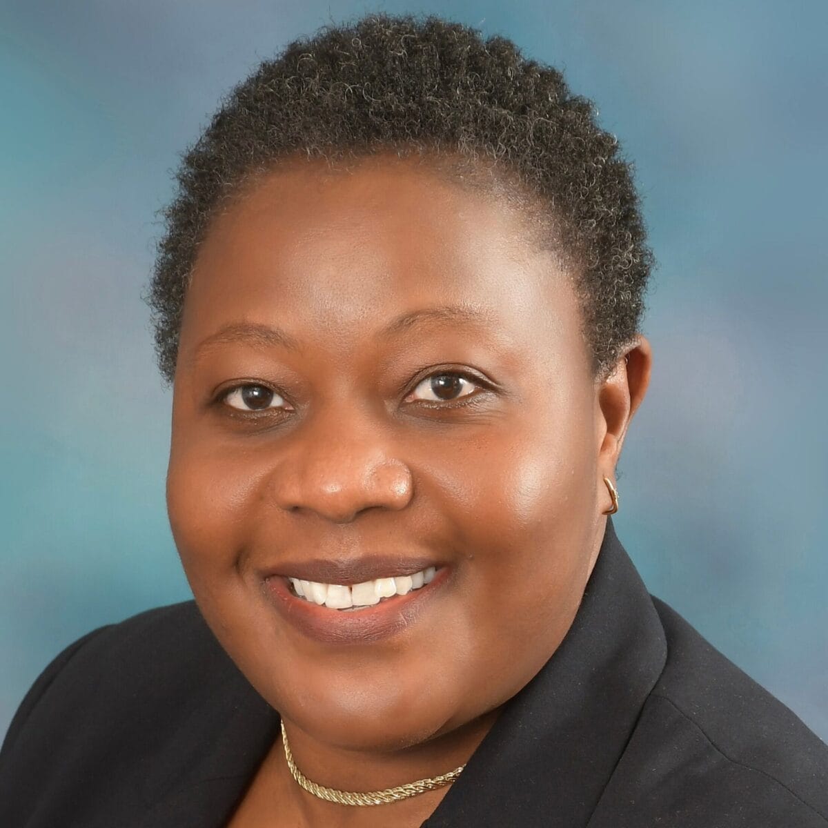Headshot of Tamala Chirwa, PCC with the International Coaching Federation. Known for coaching C-suite leaders to enhance leadership and team performance.