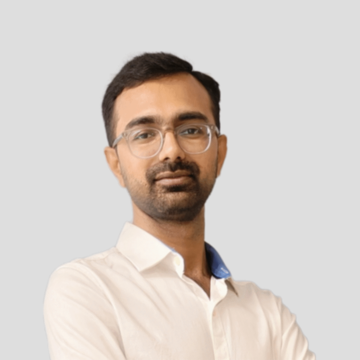 A man with glasses and a white shirt