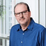 Headshot of Rony Gruber, PCC with the International Coaching Federation. Honored with Israel’s Presidential Volunteer Award, he empowers leaders through transformative coaching and storytelling.